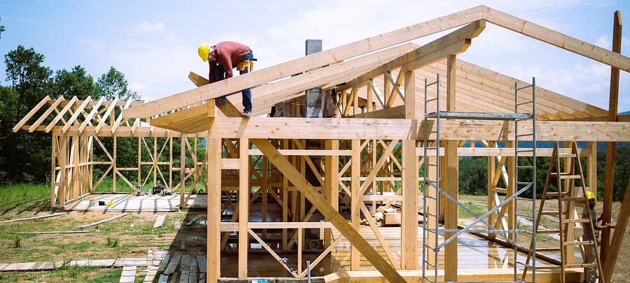 builder working roof wooden house